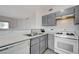 Well-lit kitchen featuring a gas stove, gray cabinets, and tile flooring at 1881 W Alexander Rd # 1135, North Las Vegas, NV 89032