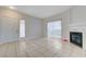 Bright and spacious living room featuring tile floors, a fireplace and exterior access at 1881 W Alexander Rd # 1135, North Las Vegas, NV 89032