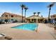 Community pool featuring lounge chairs, landscaping and community buildings on a sunny day at 1881 W Alexander Rd # 1135, North Las Vegas, NV 89032