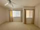 Spacious bedroom with two windows, ceiling fan and neutral carpet at 2282 Camel Mesa Dr, Laughlin, NV 89029