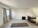Bright living room featuring a fireplace and large window with modern curtains at 2282 Camel Mesa Dr, Laughlin, NV 89029