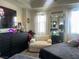 Cozy bedroom with a plush chair, large mirror, and bright windows at 2455 W Serene Ave # 709, Las Vegas, NV 89123