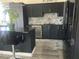 Modern kitchen featuring dark cabinets, granite countertops, and stainless steel appliances at 2455 W Serene Ave # 709, Las Vegas, NV 89123