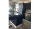 Updated kitchen with dark cabinets, granite island with seating, and stainless steel appliances at 2455 W Serene Ave # 709, Las Vegas, NV 89123