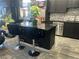 Updated kitchen with dark cabinets, granite island with seating, and stainless steel appliances at 2455 W Serene Ave # 709, Las Vegas, NV 89123