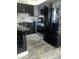 Sleek kitchen featuring black cabinetry, stainless steel appliances, and modern finishes at 2455 W Serene Ave # 709, Las Vegas, NV 89123
