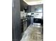 Stylish kitchen featuring sleek black cabinetry, stainless steel appliances, and mosaic backsplash at 2455 W Serene Ave # 709, Las Vegas, NV 89123
