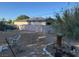 A spacious backyard with a tree stump and a pink brick wall at 2520 Sunrise St, Las Vegas, NV 89101