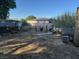 A messy backyard with dry grass and various items scattered throughout at 2520 Sunrise St, Las Vegas, NV 89101