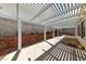 Covered patio featuring a concrete surface, brick walls and mature landscaping at 274 Pear Meadow St, Henderson, NV 89012