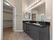 Bathroom with double vanity sink, black granite countertops and walk in closet at 274 Pear Meadow St, Henderson, NV 89012