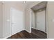 Hallway with wood floors offering a view to a secondary hall and entry door at 274 Pear Meadow St, Henderson, NV 89012
