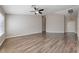 Open living room with a ceiling fan, neutral walls and stylish wood flooring at 274 Pear Meadow St, Henderson, NV 89012