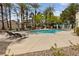 A refreshing pool surrounded by lounge chairs and lush landscaping provides a resort-style escape at 274 Pear Meadow St, Henderson, NV 89012