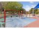 An outdoor swing set surrounded by mature trees and a shade covering at 274 Pear Meadow St, Henderson, NV 89012