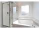 Bright bathroom featuring a bathtub with shower and updated fixtures at 2878 Chalk Mountain Ct, Las Vegas, NV 89142
