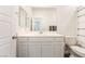 Bathroom featuring white vanity, mirror, and toilet with a white and green shower curtain at 2878 Chalk Mountain Ct, Las Vegas, NV 89142