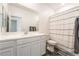 Bathroom featuring white vanity, mirror, and shower with a white and green curtain at 2878 Chalk Mountain Ct, Las Vegas, NV 89142