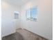 Bright bedroom featuring neutral carpet, white walls, and a large window offering ample natural light at 2878 Chalk Mountain Ct, Las Vegas, NV 89142