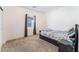 Cozy bedroom featuring a comfortable bed, soft carpet, and a window letting in natural light at 2878 Chalk Mountain Ct, Las Vegas, NV 89142