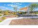 Community park with walking path, playground, seating, shade structure, and desert landscaping at 2878 Chalk Mountain Ct, Las Vegas, NV 89142
