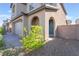 Close up of a home exterior featuring a blue front door, two-car garage, and desert landscaping at 2878 Chalk Mountain Ct, Las Vegas, NV 89142