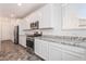 Modern kitchen with stainless steel appliances, white cabinets and elegant granite countertops at 2878 Chalk Mountain Ct, Las Vegas, NV 89142