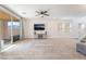 Spacious living room with a ceiling fan, sliding glass doors, and neutral colored walls at 2878 Chalk Mountain Ct, Las Vegas, NV 89142
