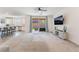 Open-concept living room featuring neutral walls, a ceiling fan, and sliding glass doors at 2878 Chalk Mountain Ct, Las Vegas, NV 89142