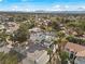 Beautiful aerial view of this home and its community in a serene neighborhood with lush trees and landscaping at 3010 La Mesa Dr, Henderson, NV 89014