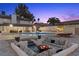 Inviting backyard with a pool, fire pit, and comfortable seating at 3010 La Mesa Dr, Henderson, NV 89014