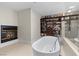 Bright bathroom featuring standalone tub, fireplace, and custom-built closet shelving at 3010 La Mesa Dr, Henderson, NV 89014