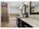 Elegant bathroom features stone countertops, dual sinks, tub, and glass shower at 3010 La Mesa Dr, Henderson, NV 89014