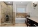 Bright bathroom featuring a glass enclosed shower and stone countertops at 3010 La Mesa Dr, Henderson, NV 89014