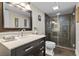 Modern bathroom features new vanity, a large mirror, and an enclosed glass shower at 3010 La Mesa Dr, Henderson, NV 89014