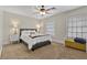 Cozy bedroom featuring a queen-sized bed, ceiling fan, and two windows with natural light at 3010 La Mesa Dr, Henderson, NV 89014