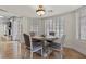 Cozy breakfast nook with round table, four chairs, travertine floors and bright natural light at 3010 La Mesa Dr, Henderson, NV 89014