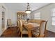 Formal dining room featuring hardwood floors, elegant chairs, large windows and a chandelier at 3010 La Mesa Dr, Henderson, NV 89014