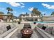 Inviting outdoor firepit with built-in seating creates a cozy atmosphere for gatherings in the backyard at 3010 La Mesa Dr, Henderson, NV 89014