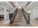 Expansive foyer with a dramatic staircase, iron railings, and elegant details creating a welcoming atmosphere at 3010 La Mesa Dr, Henderson, NV 89014