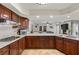 Gourmet kitchen with stone countertops, stainless appliances, and a seamless view into the inviting living area at 3010 La Mesa Dr, Henderson, NV 89014