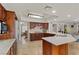 Bright, open kitchen featuring granite countertops, stainless steel appliances, and a view of the dining and living areas at 3010 La Mesa Dr, Henderson, NV 89014