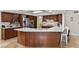 Well-equipped kitchen boasting stainless steel appliances, custom cabinetry, and a spacious island with bar seating at 3010 La Mesa Dr, Henderson, NV 89014