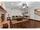 Bright living room featuring hardwood floors, a brick fireplace, neutral decor, and comfortable sofas at 3010 La Mesa Dr, Henderson, NV 89014