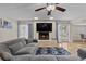 Cozy living room with a brick fireplace, large television, comfortable seating, and access to the backyard at 3010 La Mesa Dr, Henderson, NV 89014