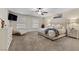 Spacious main bedroom with plush carpeting, seating area, a ceiling fan and a king bed at 3010 La Mesa Dr, Henderson, NV 89014