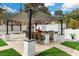 Charming outdoor kitchen features a grill, pizza oven, and bar, perfect for al fresco dining and entertaining at 3010 La Mesa Dr, Henderson, NV 89014