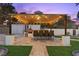 Charming outdoor kitchen with a pizza oven and seating area at 3010 La Mesa Dr, Henderson, NV 89014