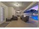 Comfortable outdoor living space featuring stylish seating, ceiling fan, and access to a sparkling pool with waterslide at 3010 La Mesa Dr, Henderson, NV 89014
