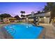 Luxurious pool with a slide, spa, and covered patio area at 3010 La Mesa Dr, Henderson, NV 89014